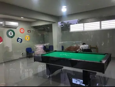 a man in a room with a pool table at Apartamento Tipo resort-style space in Santiago de los Caballeros