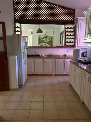 a kitchen with a white refrigerator and a tile floor at Casa de Campo Golf, Villa La Romana in La Romana