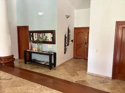 a living room with a mirror and a table at Casa de Campo Golf, Villa La Romana in La Romana