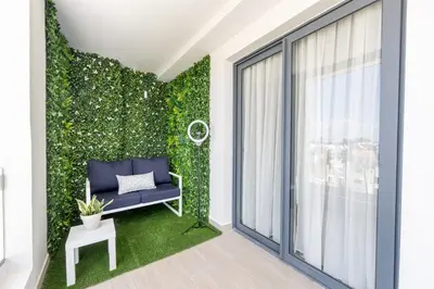 a room with a green wall with a bench and a window at Corner Penthouse with Ocean and City Views with a Content Creator Hub in Punta Cana