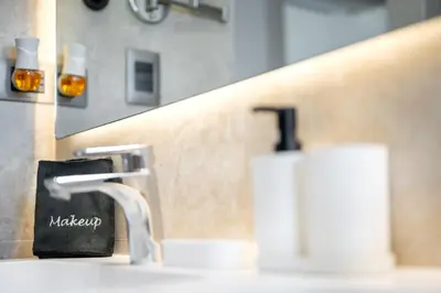 a bathroom sink with a faucet and a soap dispenser at Corner Penthouse with Ocean and City Views with a Content Creator Hub in Punta Cana