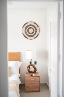 a bedroom with a bed and a table with a lamp at Corner Penthouse with Ocean and City Views with a Content Creator Hub in Punta Cana