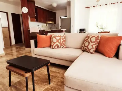 a living room with a couch and a table at Zen Apartment in Punta Cana