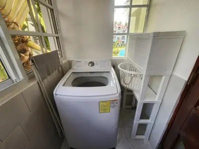 a washing machine in a small room with a window at Zen Apartment in Punta Cana