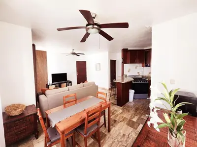 a living room with a couch and a ceiling fan at Zen Apartment in Punta Cana