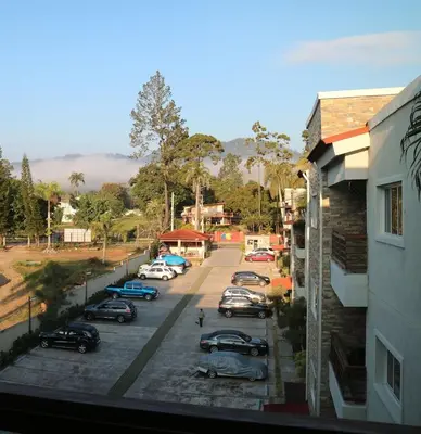 a view of a street with cars parked in a parking lot at Luxury Apartment close to centre of Jarabacoa in Jarabacoa