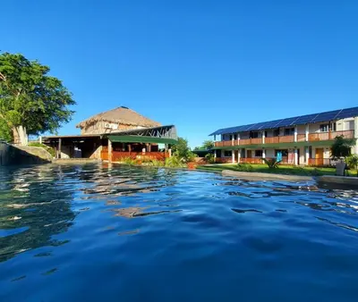 a view of a river with buildings in the background at Habitacion 2 en Dani's Guest House in Las Galeras