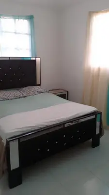 a large bed in a bedroom with a window at Queen Bmazazhi Stay in San Pedro de Macorís