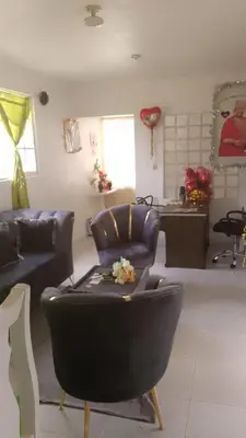 a living room with two chairs and a couch at Queen Bmazazhi Stay in San Pedro de Macorís