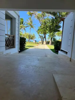 an empty driveway leading into a building with trees in the background at Beautiful apartment in Playa Dorada in San Felipe de Puerto Plata