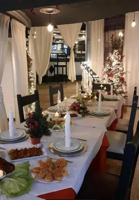 a long dining table with a christmas tree in the background at Costa Azul Skibel 2 br in Santo Domingo