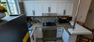 a kitchen with white cabinets and a stove top oven at Margarita 4toB in Marilópez