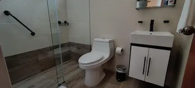 a bathroom with a toilet and a glass shower at Margarita 4toB in Marilópez