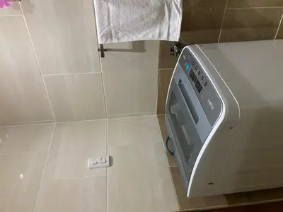 a washing machine in a bathroom with a tiled floor at Residencial Don Pedro 1103 in Santo Domingo
