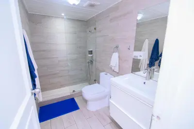 a bathroom with a white toilet and a sink at Tranquil 3 Bedroom Apartment - Pool & Private Beach Access in Punta Cana