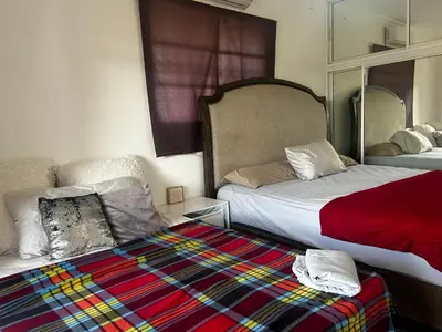 a hotel room with two beds and a blanket at Casa con jacuzzi in Santiago de los Caballeros