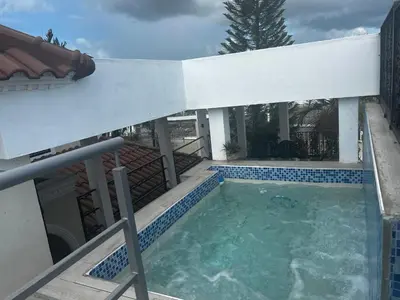 a swimming pool in the middle of a house at Casa con jacuzzi in Santiago de los Caballeros