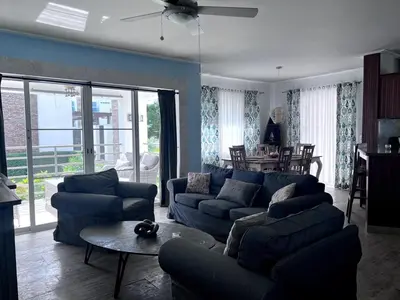a living room with a blue couch and a table at Jojo's Caribbean Retreat in Punta Cana