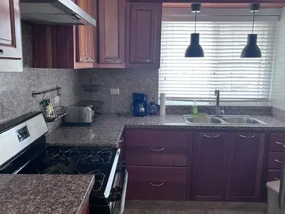 a kitchen with a sink and a stove top oven at Jojo's Caribbean Retreat in Punta Cana
