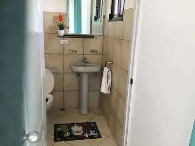 a small bathroom with a sink and a toilet at Villa vacances de reve in Sosúa