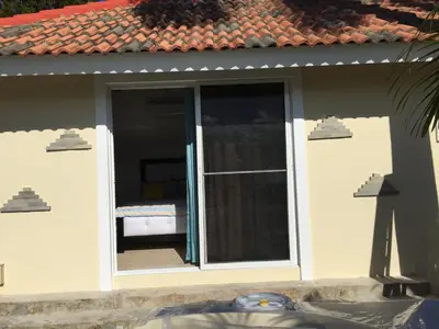a room with a sliding glass door with a bed outside at Villa vacances de reve in Sosúa