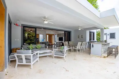 a patio with a table and chairs and a kitchen at Casa Linda Villa 767 - Sosua in Sosúa