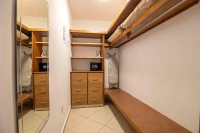 a walk in closet with wooden drawers and shelves at Casa Linda Villa 767 - Sosua in Sosúa