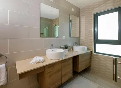 a bathroom with two sinks and a mirror at Amare Residences - Beachfront complex in Las Terrenas