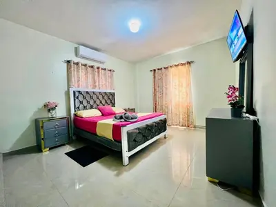 a bedroom with a bed and a flat screen tv at Oasis de Paz 04 in Colorado
