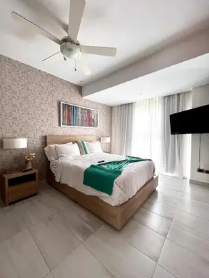 a bedroom with a bed and a ceiling fan at Comodo departamento centrico SD in Santo Domingo