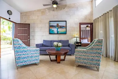 a living room with a blue couch and chairs at Casa Linda Villa 722 - Sosua - BBQ - Washer in Sosúa