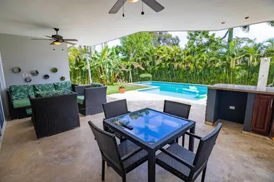 a patio with a table and chairs and a pool at Casa Linda Villa 722 - Sosua - BBQ - Washer in Sosúa