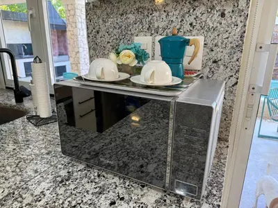 a counter with two plates and a tea set on it at Juan Dolio House 2BR y Patio in Los Corrales