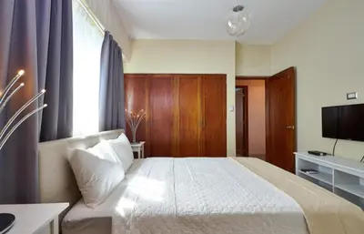a hotel room with a bed and a television at YOUR SPACE IN SANTO DOMINGO Gazcue in Colorado