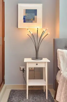 a table with a potted plant on it next to a bed at YOUR SPACE IN SANTO DOMINGO Gazcue in Colorado