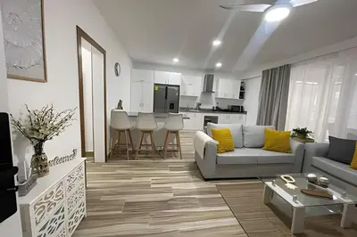 a living room with a couch and a table at Sweet Home Bayahibe in Bayahibe