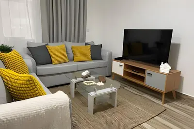 a living room with a couch and a flat screen tv at Sweet Home Bayahibe in Bayahibe