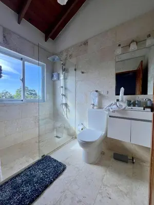 a bathroom with a toilet and a sink and a shower at Sosua Residence by CJDR in Sosúa