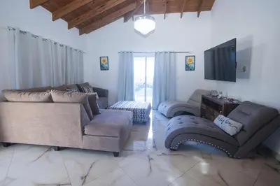 a living room with two couches and a television at Sosua Residence by CJDR in Sosúa