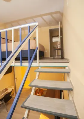 a room with three bunk beds and a staircase at JEYMAR STUDIO rd in Santo Domingo