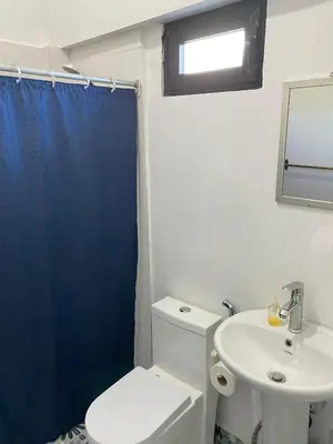 a bathroom with a white toilet and a sink at Little Room Airport By Merengue House in Monte Adentro