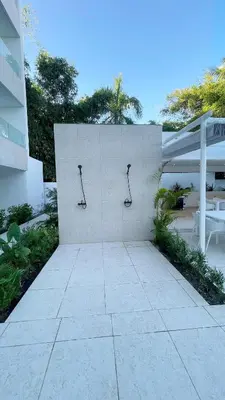 a concrete wall with three glasses on it at Luxury penthouse with panoramic ocean view in Punta Cana