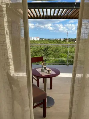 a table and a chair on a balcony with a view at Vibe Residence Gorgeous Penthouse with Jacuzzi & outstanding Sea & Natural Preserve view in La Laguna
