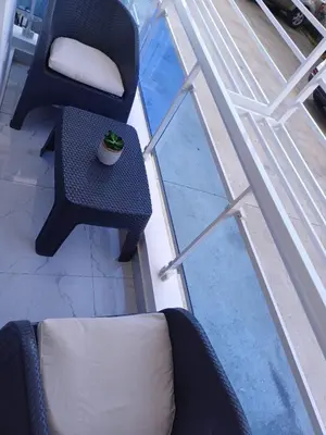 two chairs and a table with a plant on a balcony at Residencial Génesis III in Colorado