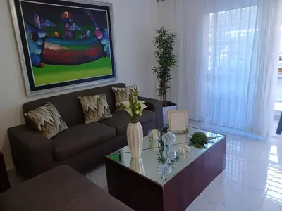 a living room with a couch and a coffee table at Residencial Génesis III in Colorado