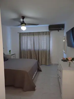 a bedroom with a bed and a ceiling fan at Residencial Génesis III in Colorado