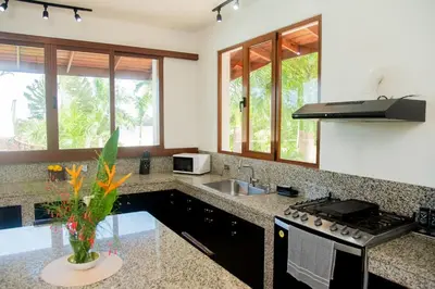 a kitchen with a sink and a stove at Lives off Colorada Beach in La Colmena
