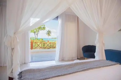 a bedroom with a bed and a window with a view at Lives off Colorada Beach in La Colmena