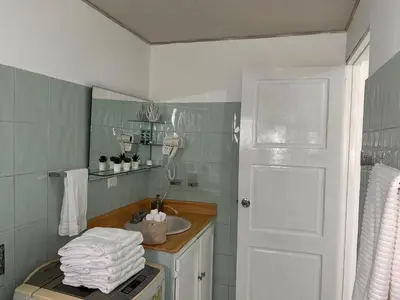 a bathroom with a sink and a counter with towels at Villas Princesa Beach Apartments in Punta Cana