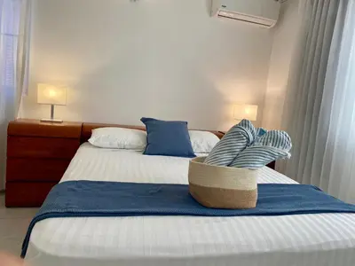 a bedroom with two beds and a basket on the bed at Villas Princesa Beach Apartments in Punta Cana